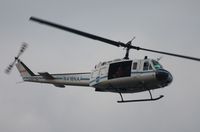 N416NA - NASA UH-1B flying over Indian River at Titusville