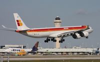 EC-JLE @ MIA - Iberia with the tower and the 16 ft shorter 747-400 in the background.