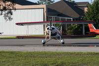 Spruce Creek Airport (7FL6) - Bi plane with private hangars in background - by Florida Metal